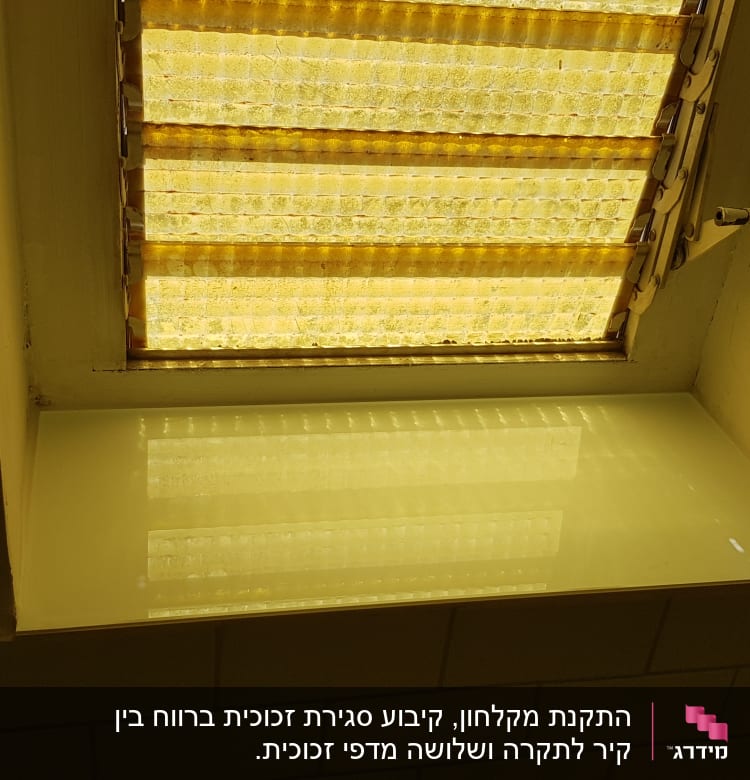זכוכית מחזירה אור מתחת לחלון עם תריסים צהובים